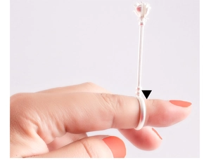 Macro shot of silver rose cigarette ring holder worn on finger with floral detail