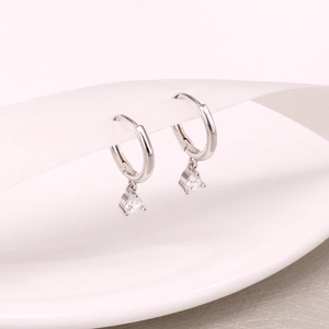 Close-up of S925 sterling silver hoop earrings with clear zircon gemstone pendants