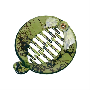 Detailed view of the olive green resin banana clip featuring a marble pattern texture