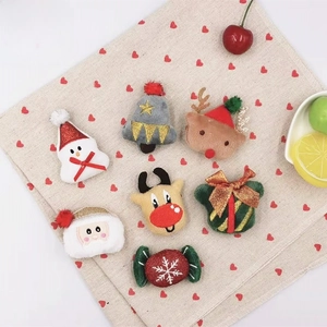 Flat lay of soft plush Christmas ornaments including snowman, tree and reindeer figurines