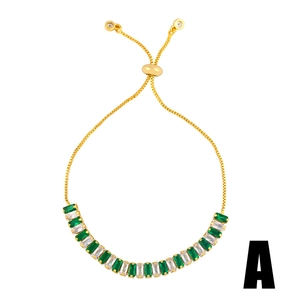 Detail of adjustable gold bracelet with green and white baguette-cut crystals