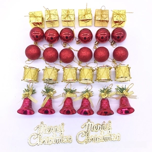Detailed close-up of 32-piece red and gold Christmas ornaments including bells and drums