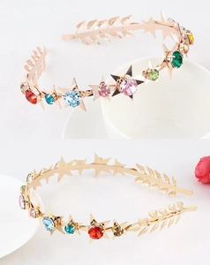 Detail of bohemian gold headband with colorful rhinestones, stars and leaf accents