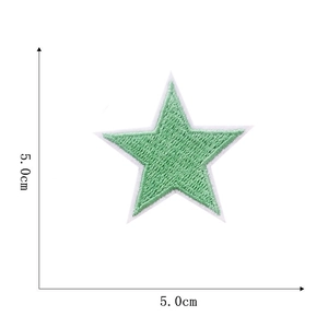 Macro detail of a 5cm light green star embroidery patch with white border texture