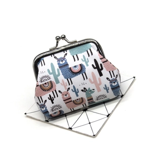 Close-up of small canvas coin purse with cute alpaca and cactus print and metal clasp