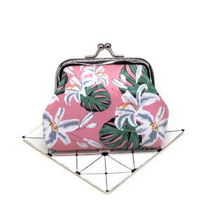 Detail of floral coin purse with silver metal clasp and lily print on pink fabric