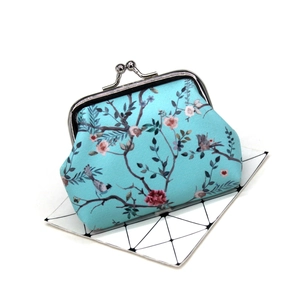 Close-up of vintage floral coin purse with silver metal clasp and bird patterns