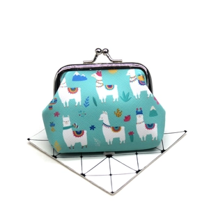Close-up of blue canvas coin purse featuring cartoon alpaca prints and metal clasp closure