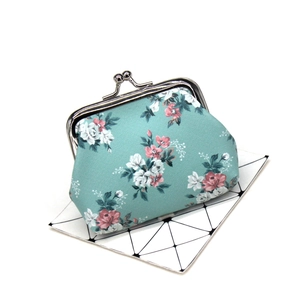 Detailed view of turquoise floral coin purse with vintage silver metal kiss-lock closure