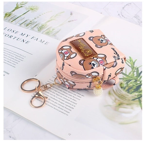 Close-up of pink mini bear backpack coin purse with pearl zipper and gold keychain