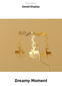 Detailed macro view of golden rotating candle holder with reindeer and snowflake charms