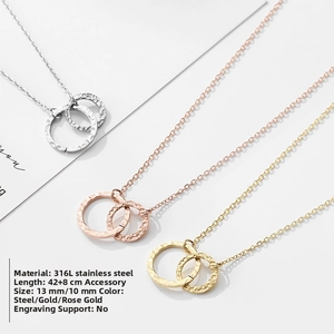 Detailed view of triple color 316L stainless steel necklaces with hammered double ring pendants