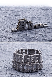 Macro detail of industrial style men's motorcycle chain bracelet in steel and gold