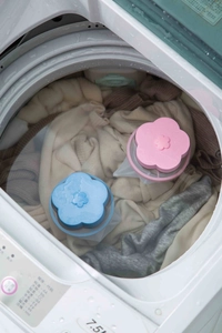 Macro shot of floating mesh laundry filter bags collecting hair lint in a washing machine