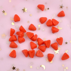 Resin strawberry charms for DIY crafts and phone cases on pink starry background