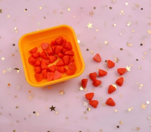 Macro shot of realistic strawberry resin charms for DIY phone case craft accessories