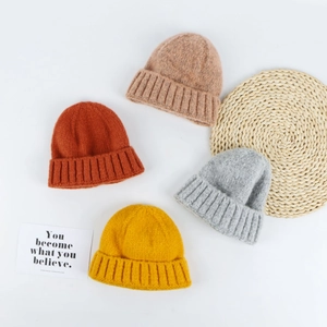 Winter knit beanies in multiple colors with ribbed cuffs on a clean white background