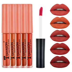 Detail showing five matte lip gloss swatches in red and orange tones with an applicator