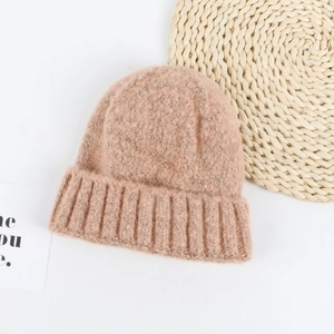 Close-up of thick pink knit texture and wide folded brim on this stylish beanie