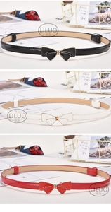 Three-color set of thin skinny belts with bow buckles in black, white, and red leather