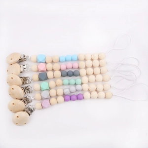 Set of 6 silicone and beech wood baby pacifier clips in various pastel colors on white background