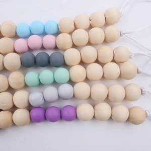 Silicone and wood baby pacifier clip chain with colorful beads on a white background