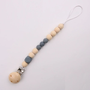 Detailed view of silicone and wood baby pacifier clip with grey beads on white background