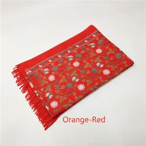 Detail of orange-red cashmere-feel shawl with exquisite floral embroidery and tassels