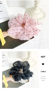 Detail of French vintage organza polka dot scrunchie and classic black hair tie
