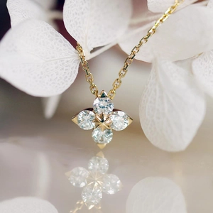 Macro shot of 14K gold-plated four-leaf clover pendant with sparkling zircon diamonds