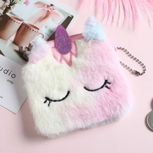 Detail of plush unicorn coin purse featuring gradient faux fur and a shiny sequin horn