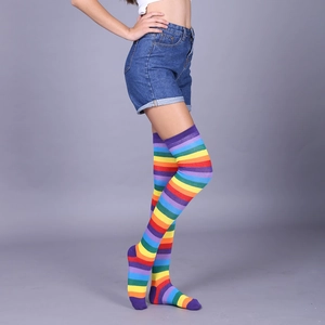 Detail view of colorful rainbow striped over-knee socks showing texture and elastic fit