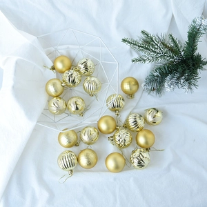 Close-up of 5cm gold Christmas ornaments with matte, glitter, and embossed textures