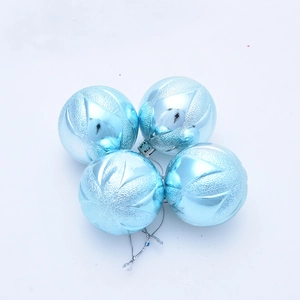 Close-up of four light blue 5cm Christmas balls with embossed texture and glitter detail