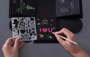 Detail of DIY explosion box template with silver glitter pen on black cardstock