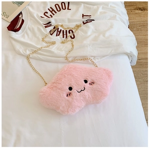 Close-up of pink fluffy cloud bag with embroidery smile and golden chain strap