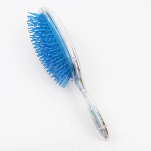 Side view of a blue glitter hairbrush with a clear handle and colorful sequins