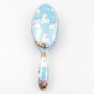 Detail view of a blue unicorn hairbrush featuring sparkling star sequins in a clear handle