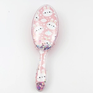 Detail of pink transparent rabbit hairbrush featuring sparkling colorful sequins inside