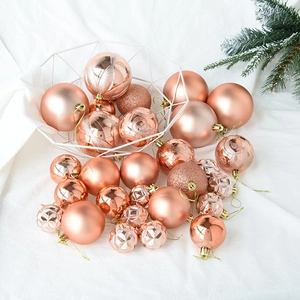 Detail of rose gold Christmas balls with matte, shiny, and glitter finishes in a basket