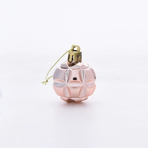 Close-up of rose gold Christmas ornament featuring elegant geometric faceted texture