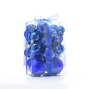 Detailed view of dark blue assorted Christmas ornaments with matte and glitter finishes in box