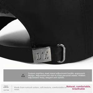 Detail of adjustable stainless steel buckle on black cotton baseball cap for custom fit