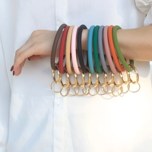 Detail of colorful silicone bangle keychains in multiple colors with gold spring hooks