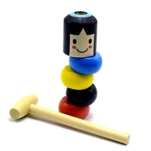 Detail of colorful wooden stackable pieces with a hammer for magic trick performance