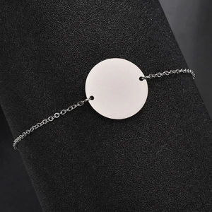 Polished stainless steel chain bracelet with a 20mm round tag on a display stand