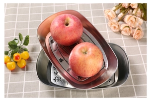 Detailed view of silver stainless steel oval tray featuring intricate embossed floral textures