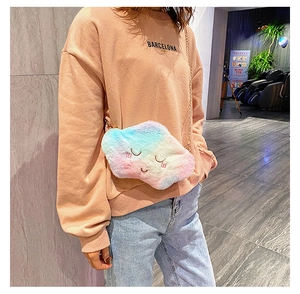 Plush rainbow cloud bag with embroidery and gold chain shown on a shoulder