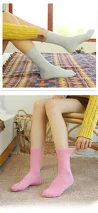 Detail of light blue and pink ribbed knit cotton socks for women in a cozy home setting