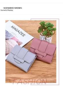 Three-fold leather wallets in grey and pink with litchi texture on wooden background